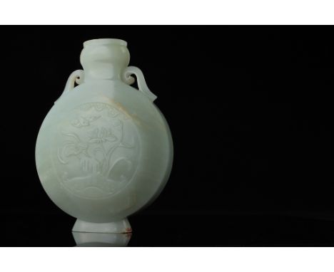 Age: Qing Dynasty  A Chinese nephrite jade moon flask vase with bulbous 'garlic' neck, flanked by scroll handles, decorated o