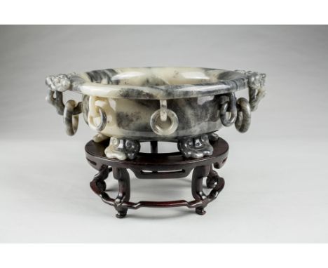 Age: Qing dynasty  Description: A very large Chinese circular form jade marriage bowl with a curled and everted rim, carved w