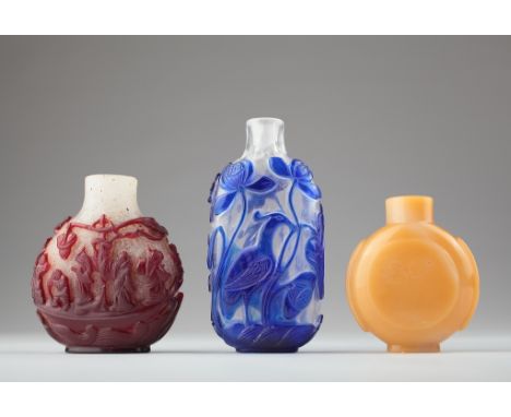 Age: Qing dynasty and later   Description: A group of three glass snuff bottles, one carved in blue to clear with a bird amon