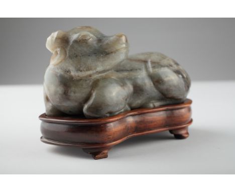 Age: Ming dynasty  Description: A charming jade water buffalo in a recumbent pose with head turned to one side, proportions n