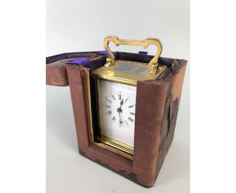Vintage carriage clock of brass with clear panels, white dial with roman numerals approximately 11cm high, along with an anti