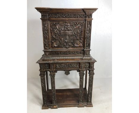 Heavily carved square cupboard on stand, carved with inscription "Venetia", cupboard with fall front, previously used as a dr