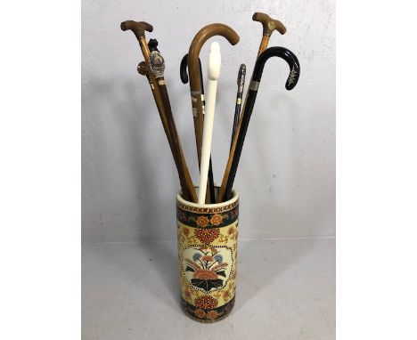 Collection of vintage walking sticks , animal head tops, horn,stone set, white metal, in a oriental style ceramic stick stand