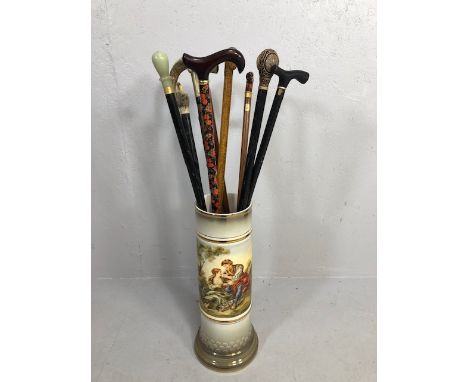 Collection of walking sticks in a ceramic stick stand , various designs, faux amber, faux bone, horn tops 10 items in total 