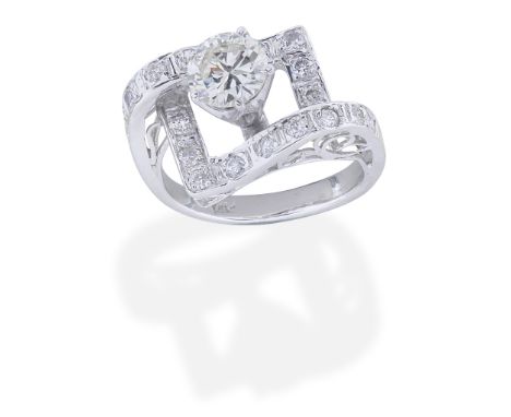 DIAMOND RINGThe brilliant-cut diamond, set within an undulating geometric diamond surround, principal diamond approx. 1.20cts