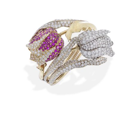 RUBY AND DIAMOND FLOWER BANGLE, MID 20TH CENTURYThe hinged bangle, designed as two intertwined tulips, set with circular-cut 