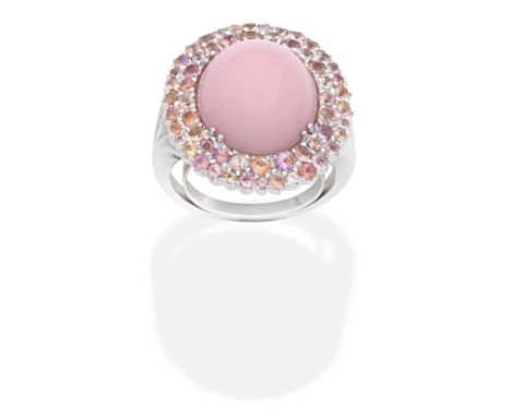 ROSSI: PINK OPAL AND GEM-SET RINGThe pink opal cabochon within a double surround of pink, orange and yellow gemstones,  signe