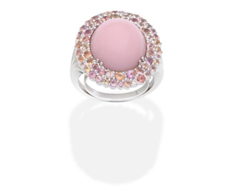 ROSSI: PINK OPAL AND GEM-SET RINGThe pink opal cabochon within a double surround of pink, orange and yellow gemstones,  signe