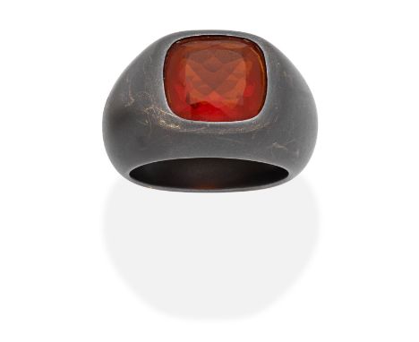 FIRE OPAL RINGThe cushion-shaped fire opal, within a mount of blackened and brushed finish, maker's mark CB, ring size approx