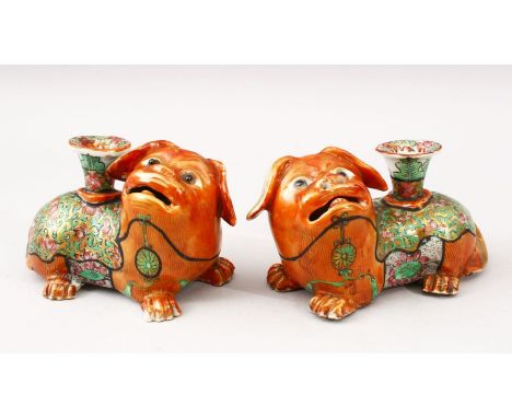 A GOOD PAIR OF 19TH CENTURY CHINESE CANTON FAMILLE ROSE PORCELAIN JOSS STICK HOLDERS, both lion dogs in recumbent positions w