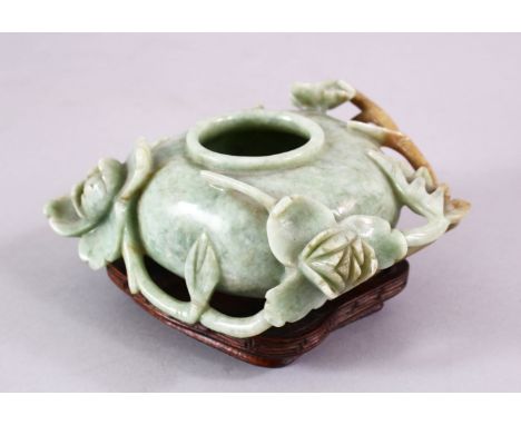 A CHINESE CARVED JADE FLORAL CARVED BRUSH WASH, on a fitted wooden base, 13 cm diameter,