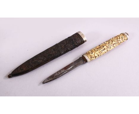 A 19TH CENTURY CARVED IVORY &amp; WOOD SCANDINAVIAN PUKKO, the handle carved with an array of flora, the scabbard also carved