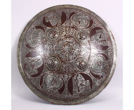 A 19TH / 20TH CENTURY INDIAN MUGHAL SILVER INLAID SHIELD, with figural decoration 46cm diameter.