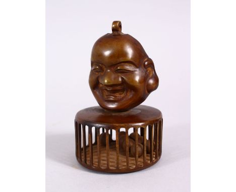A CHINESE BRONZE CHILDRENS RATTLE OF BUDDHA, the top with a mask of buddha, the cage with balls to form the rattle, 10cm.