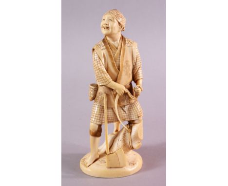 A JAPANESE MEIJI PERIOD CARVED IVORY OKIMONO OF A WOOD CUTTER, the man stood with his axe in front, upon a tree stump, the ba