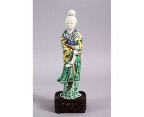 A CHINESE FAMILLE VERTE / BLANC DE CHINE PORCELAIN FIGURE OF GUANYIN &amp; STAND, stood holding a ruyi sceptre, the robes dec