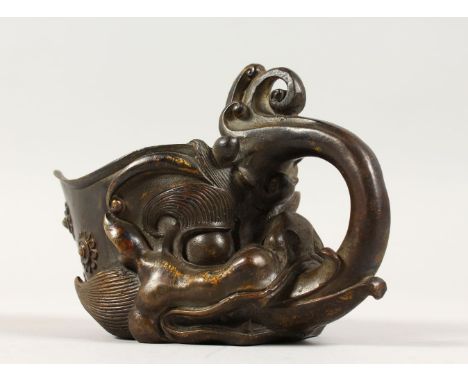 A GOOD CHINESE ARCHAIC STYLE BRONZE LIBATION CUP, cast as a dragon with flames from its mouth forming the handle, 16cm long.