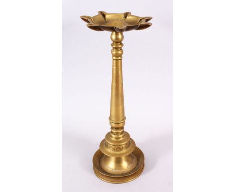 A 16TH / 17TH CENTURY INDIAN TIBETAN BRONZE OIL LAMP, carved with a lower band of calligraphy, 35cm high.