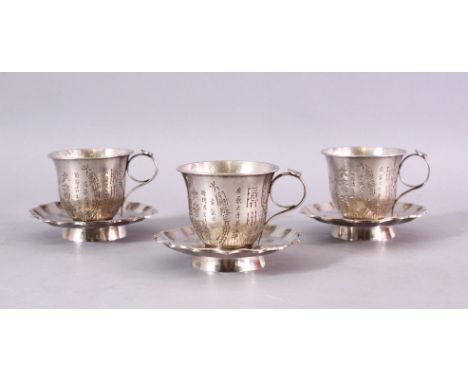 A SET OF THREE 19TH CENTURY CHINESE SILVER CUP &amp; SAUCERS, each carved with a display of flora and calligraphy, the bases 