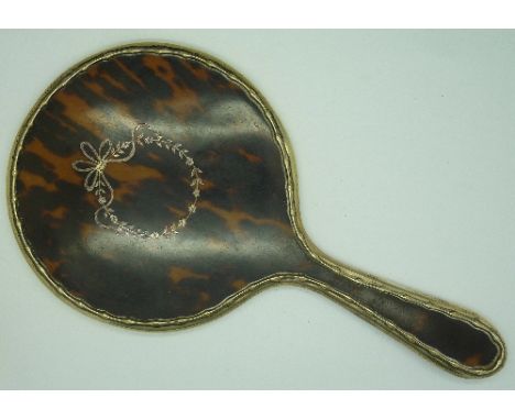 A silver and tortoiseshell hand mirror