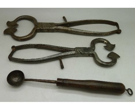 Two sugar and salt cutters and a small wooden handled spoon