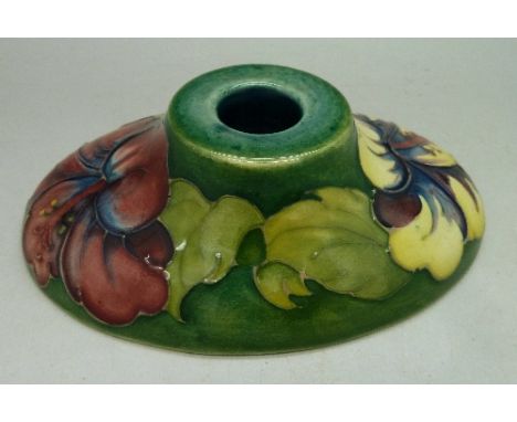 A Moorcroft hibiscus pattern candlestick, width 128mm, with label to base