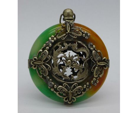 A jade and white metal pendant, diameter 5cm
