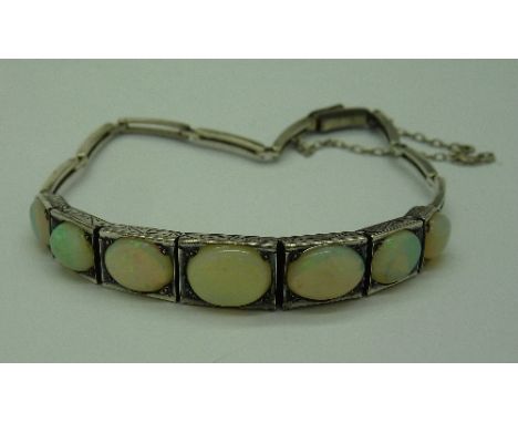 A white metal set, seven stone opal bracelet