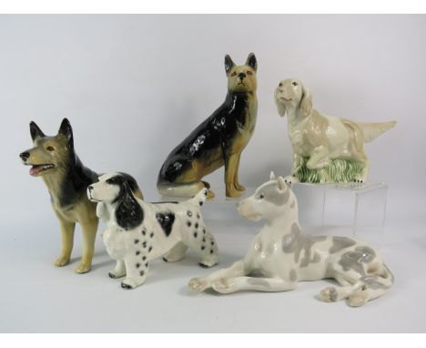 Five various ceramic dog figurines, one has had a repair to leg.