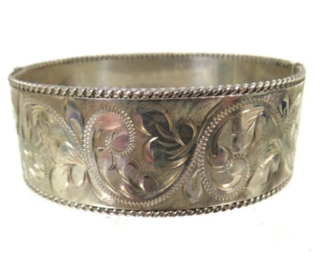 Heavy Silver oval Bangle Bracelet with good hinge and clasp. Nicely Scrolled decoration all around with hallmarks to each seg