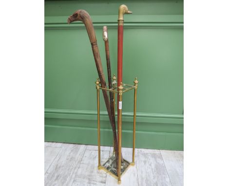 Vintage brass stick stand and three walking sticks.