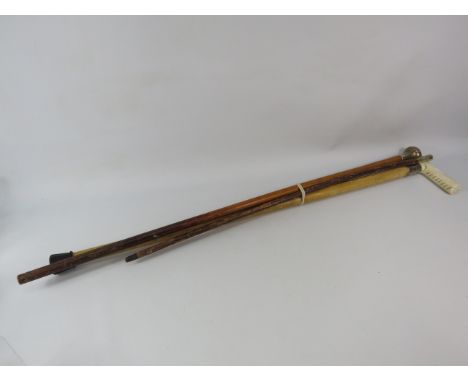Two walking sticks and a swagger stick with Sterling silver collars/ends.