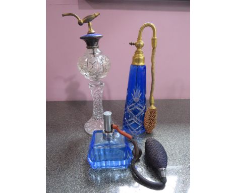 Three vintage glass scent bottles one with enamel to the top, the tallest stands 9".