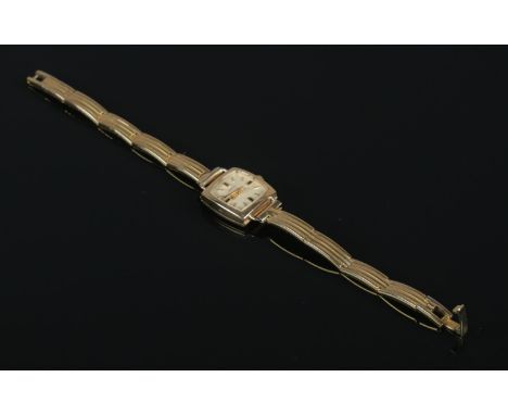 A ladies 9ct gold Marvin manual wristwatch on yellow metal strap.  