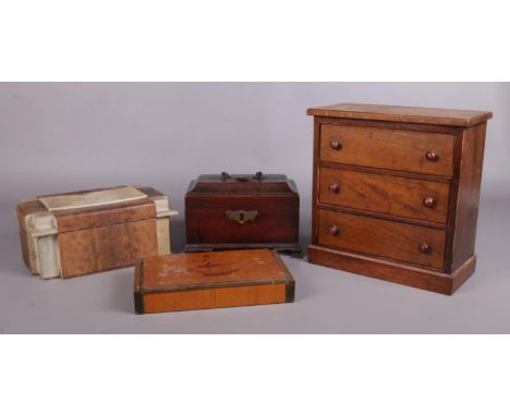 Four assorted wooden and animal skin boxes. To include a mahogany tea caddy with brass handle, a snake skin lidded box and a 