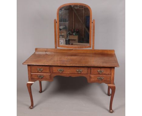 A Waring &amp; Gillow oak dressing table raised on cabriole legs. Height with mirror 158cm Length 138cm Depth 70cm.  