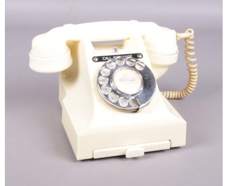 A cream vintage rotary telephone.  Crack to the back of the base.