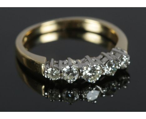 An 18ct gold five stone diamond ring. Largest stone 1/8ct. Size K½. Total weight: 3.27g  