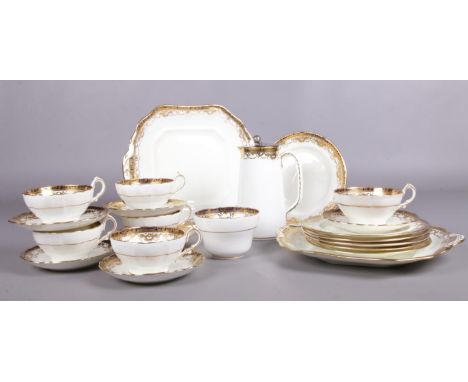 A Hammersley tea set. Design no. 14027, gold/blue pattern, 22 pieces- 6 tea plates, 6 cups/saucers, milk jug, 2 serving plate