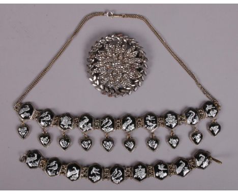 A 19th century steel brooch along with an enamel necklace and matching bracelet. Decorated with birds and flowers.  