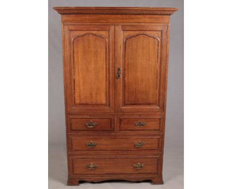 A Waring &amp; Gillow carved oak linen press. With double panel doors over four drawers, raised on ogee bracket feet. Height 