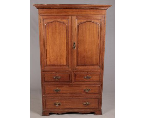 A Waring &amp; Gillow carved oak linen press. With double panel doors over four drawers, raised on ogee bracket feet. Height 