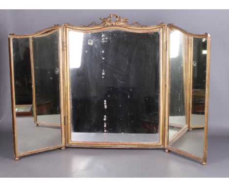 An antique gilt framed triple dressing mirror with swag pediment.  Damage beneath mirror glass.