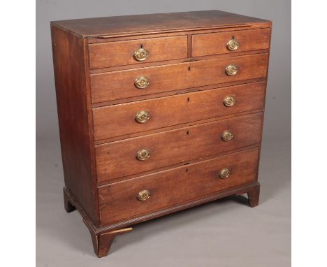 A 19th Century Oak chest of drawers. Comprising of two short over four long drawers, each with brass handles and on bracket f