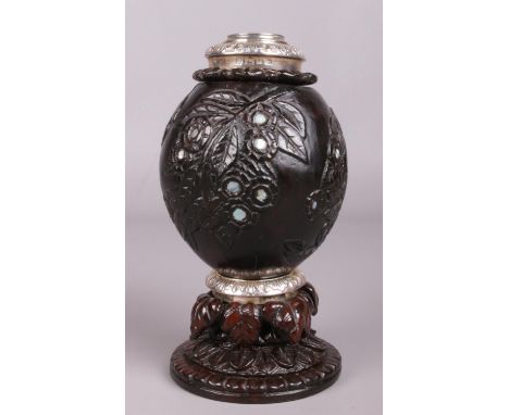 A George IV silver mounted coconut and treen tea caddy with carved decoration and mother of pearl inlay. Assayed Sheffield 18