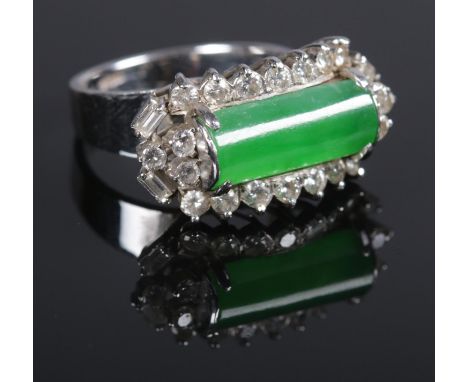 A white metal, diamond and jade coloured stone cluster ring. Set with twenty four brilliant and baguette cut diamonds framing