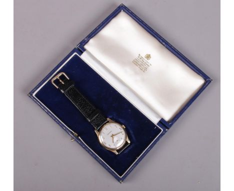 A gents 9ct gold Garrard manual wristwatch on leather strap. In original box.  Running.