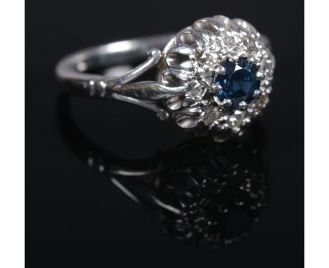 An 18ct white gold sapphire and diamond cluster ring. Size K. 4.42g.  Good condition.