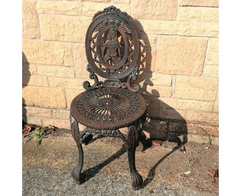 Cast iron garden chair with a figure to the back panel 