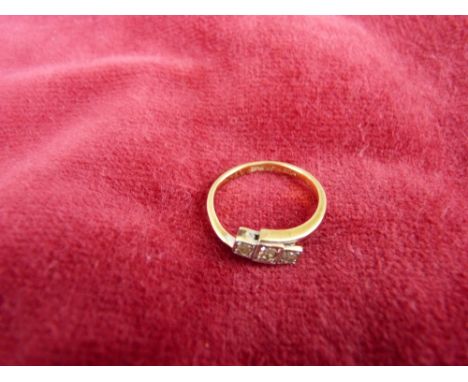 AN EIGHTEEN CARAT GOLD THREE-STONE DIAMOND RING each in a square setting, visual estimate 0.8 carats, total 2.4 grms, size L